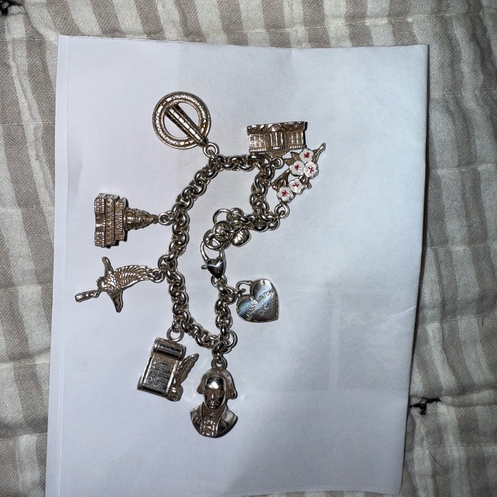 Silver DC charm bracelet.